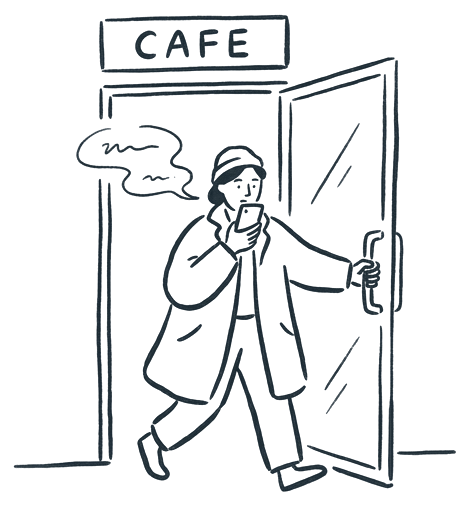A person walking out of a cafe, talking into their phone.